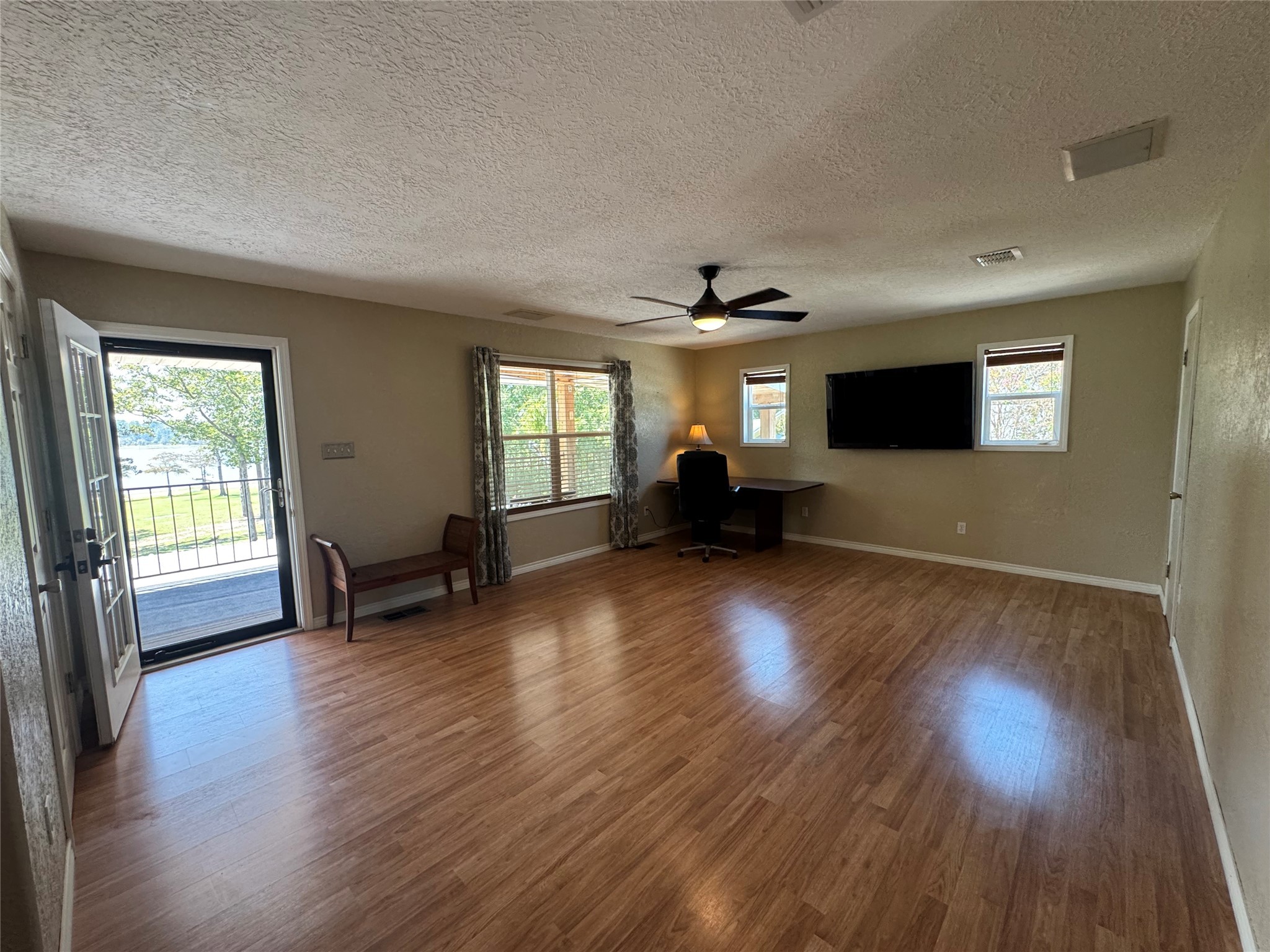 763 Mill Creek Acres Road Brookeland, TX 75931 - Photo 30 of 50 a view of empty room with wooden floor and fan