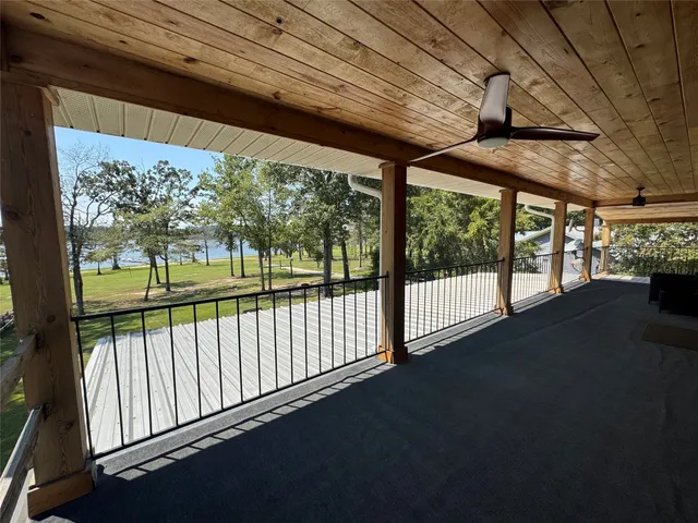 a view of porch with a floor to ceiling window and wooden floor