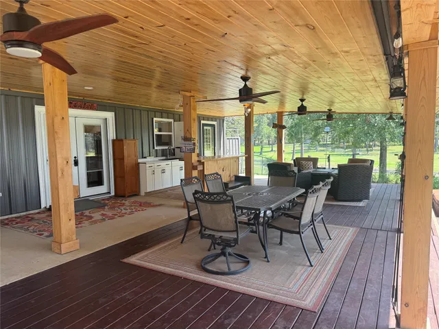 a view of a patio with table and chairs with wooden floor