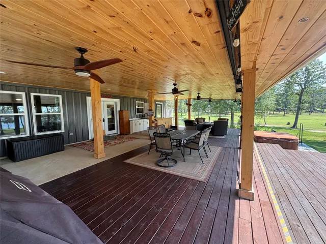 a view of a patio with table and chairs with wooden floor