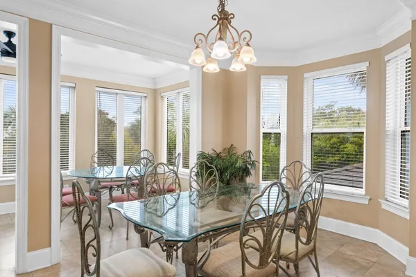 a view of a dining room with furniture large windows and wooden floor