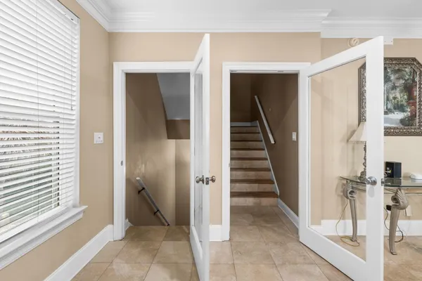 a view of a hallway with a door and stairs
