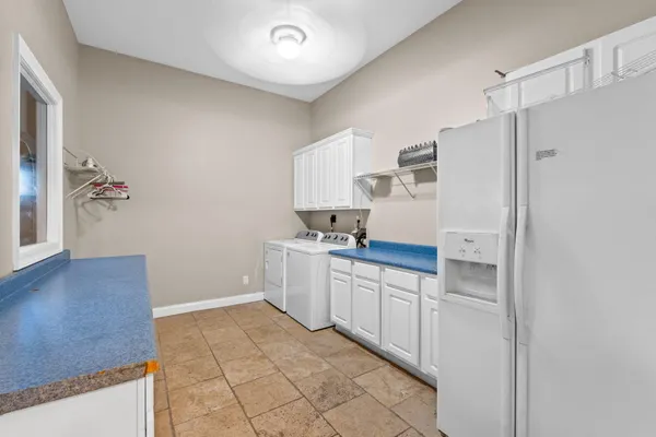 a kitchen with a refrigerator and a sink