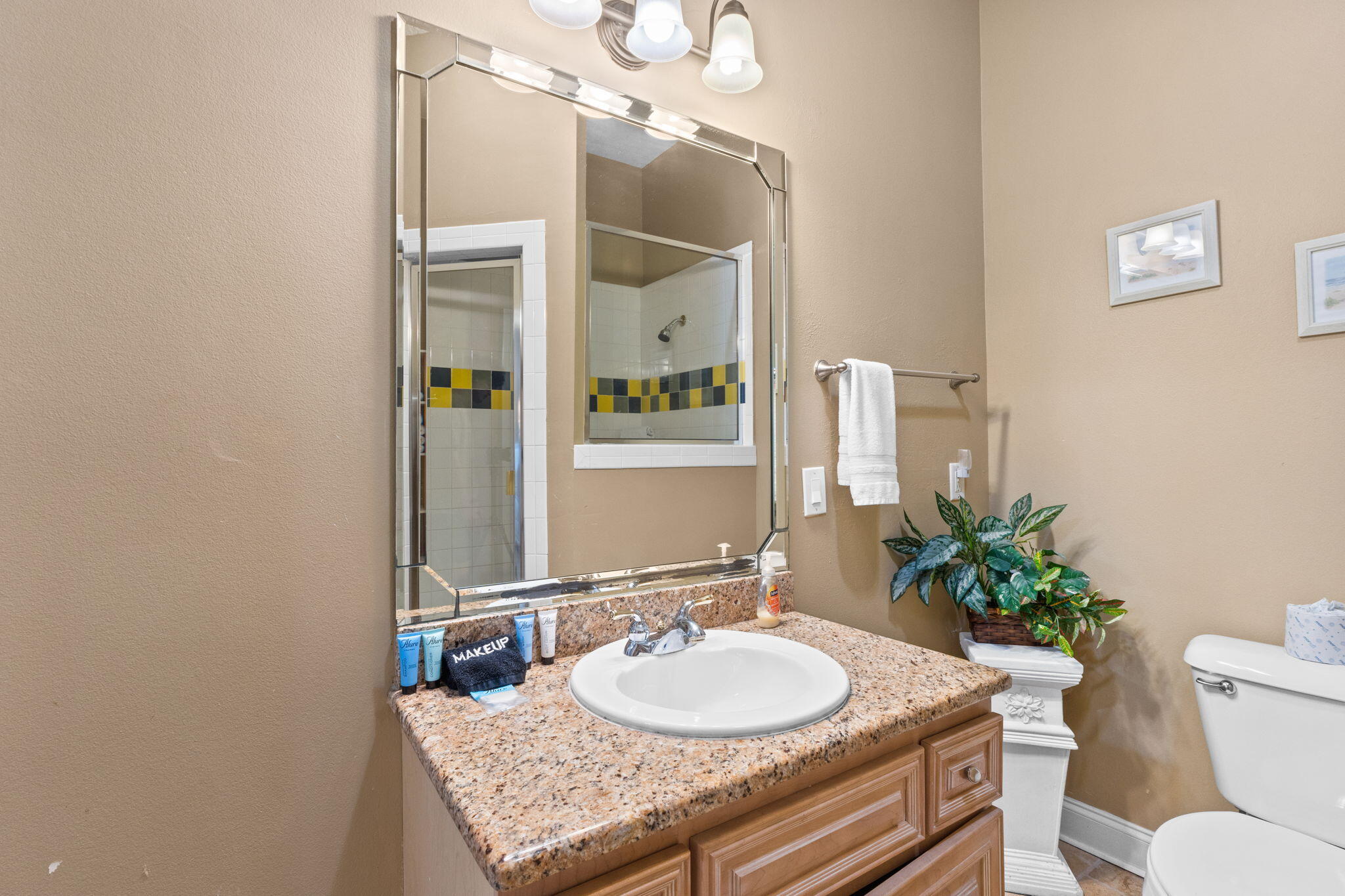 56 Terra Cotta Way Destin, FL 32541 - Photo 27 of 50 a bathroom with a granite countertop sink and a mirror with toilet