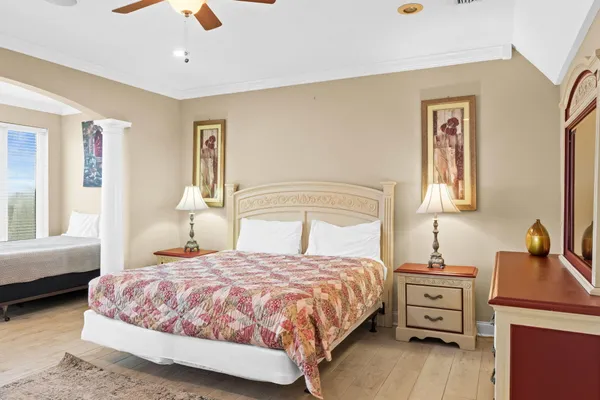 a bedroom with a bed and wooden floor