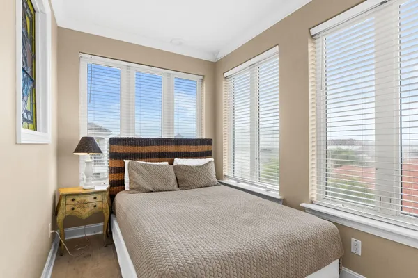 a bedroom with a large bed and a large window