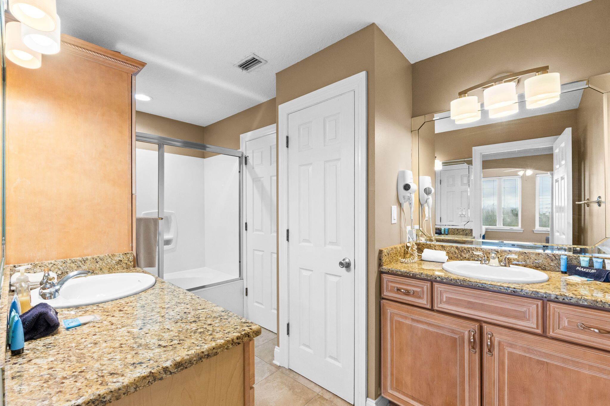 56 Terra Cotta Way Destin, FL 32541 - Photo 37 of 50 a bathroom with a granite countertop sink and a mirror