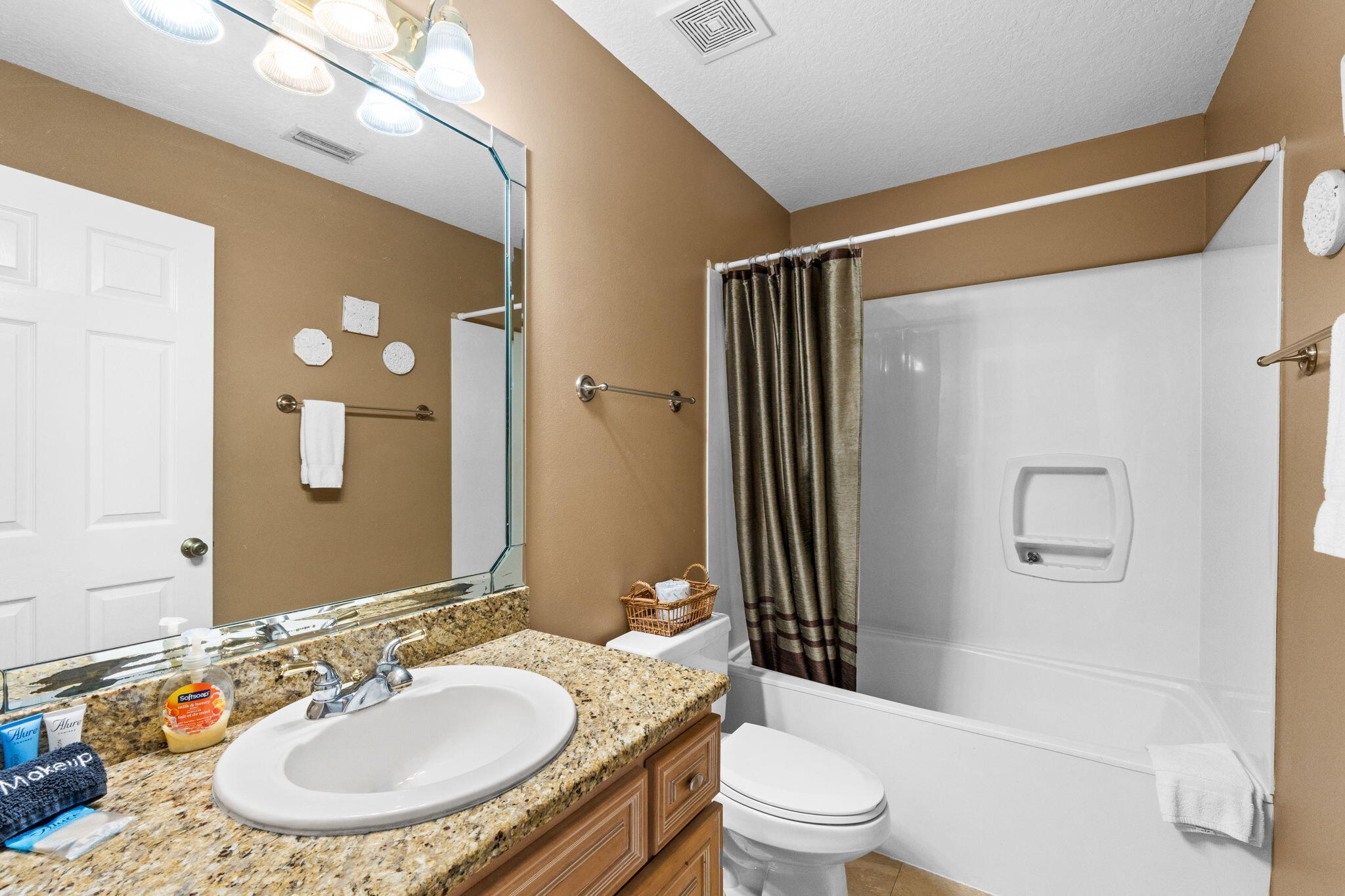56 Terra Cotta Way Destin, FL 32541 - Photo 39 of 50 a bathroom with a granite countertop sink toilet a mirror a vanity and shower