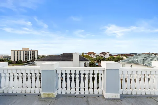 a view of a balcony with wooden fence