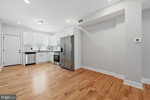 a view of kitchen with wooden floor