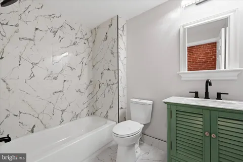 a bathroom with a toilet sink and bathtub