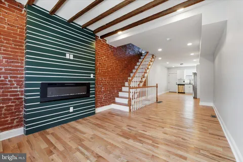 a view of entryway and hall with wooden floor
