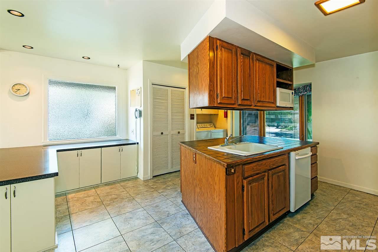 610 Robin Street Reno, NV 89509 - Photo 11 of 23 a kitchen with a stove and a refrigerator