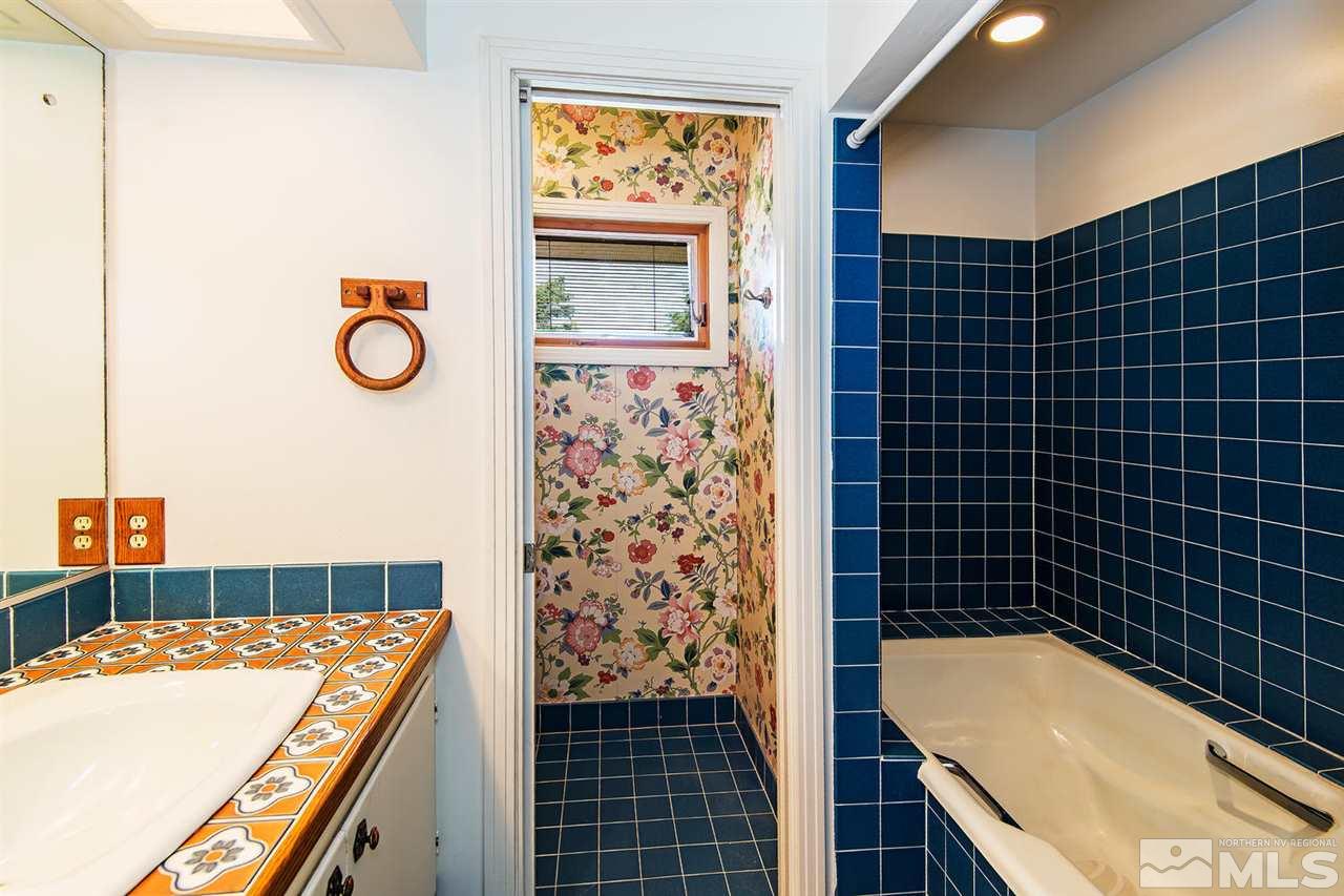 610 Robin Street Reno, NV 89509 - Photo 16 of 23 a bathroom with a bathtub and shower