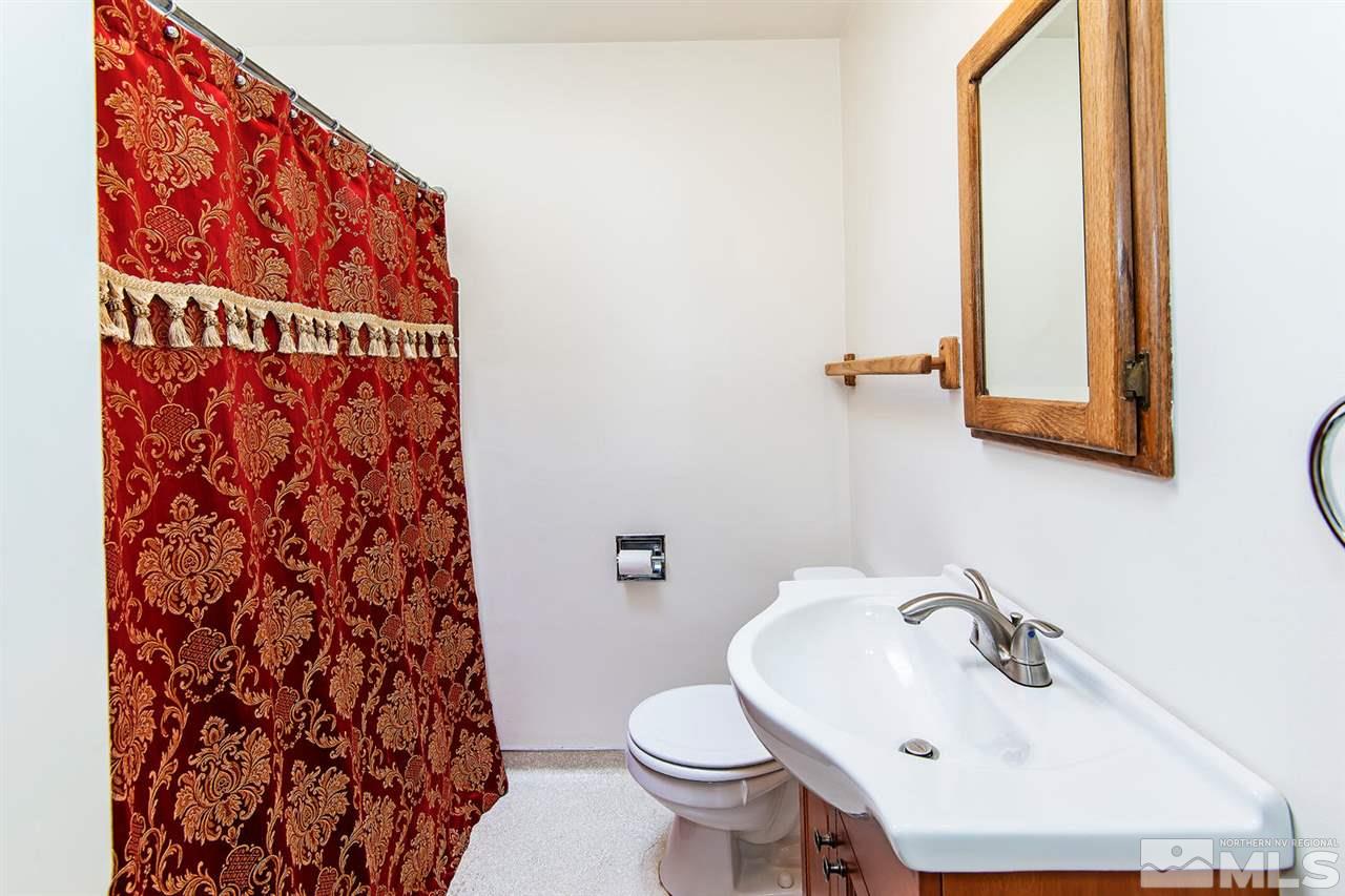 610 Robin Street Reno, NV 89509 - Photo 18 of 23 a bathroom with a sink and mirror with toilet