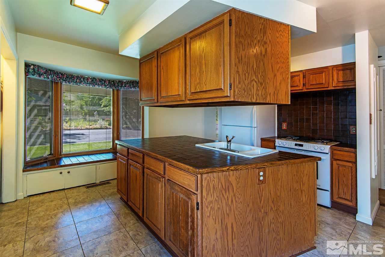 610 Robin Street Reno, NV 89509 - Photo 23 of 23 a kitchen with stainless steel appliances granite countertop a stove a sink and a microwave