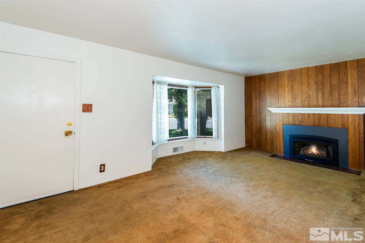 610 Robin Street Reno, NV 89509 - Photo 4 of 23 a view of an empty room with a window and a fireplace