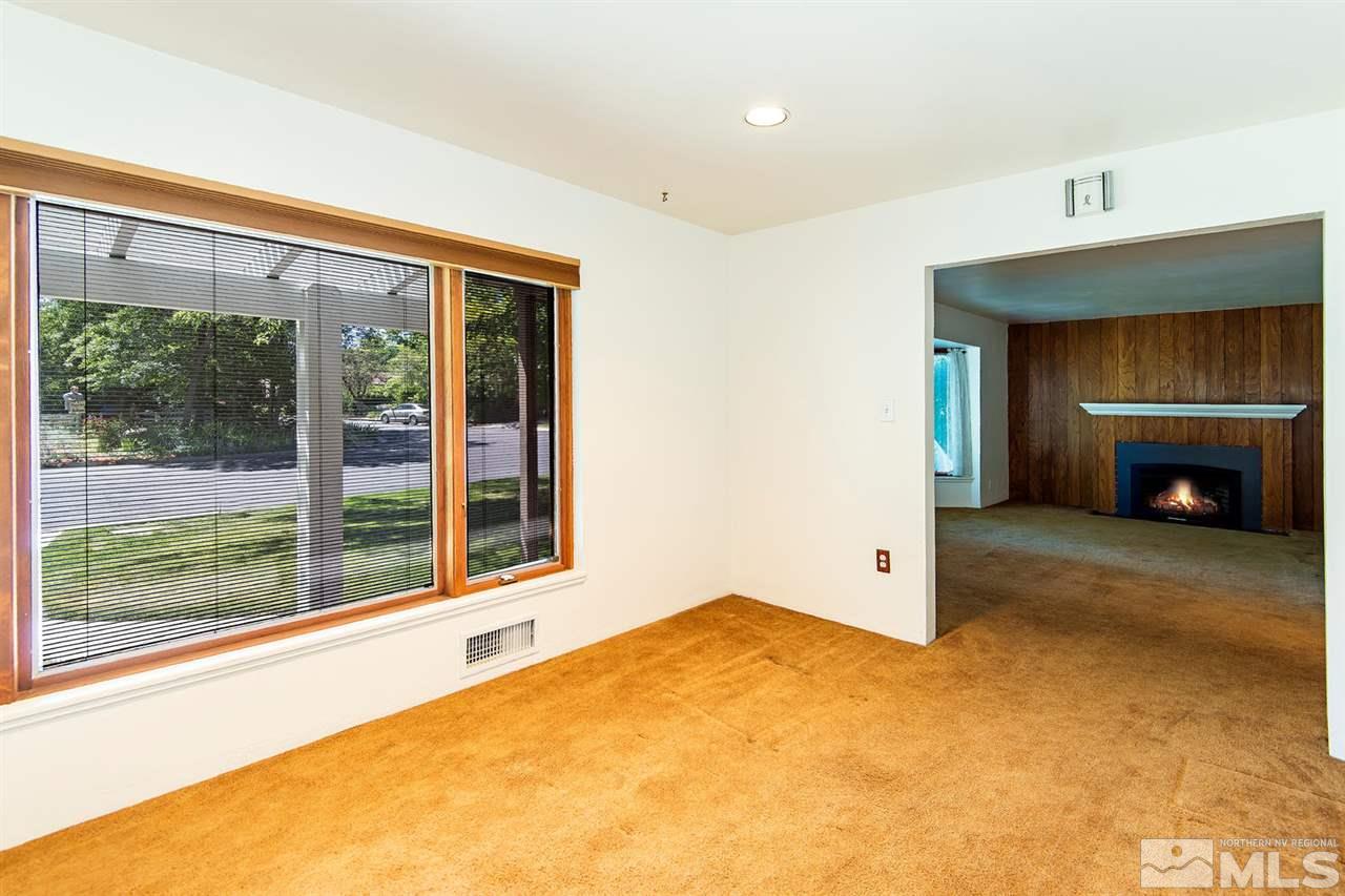 610 Robin Street Reno, NV 89509 - Photo 8 of 23 a view of an empty room with a fireplace and a window