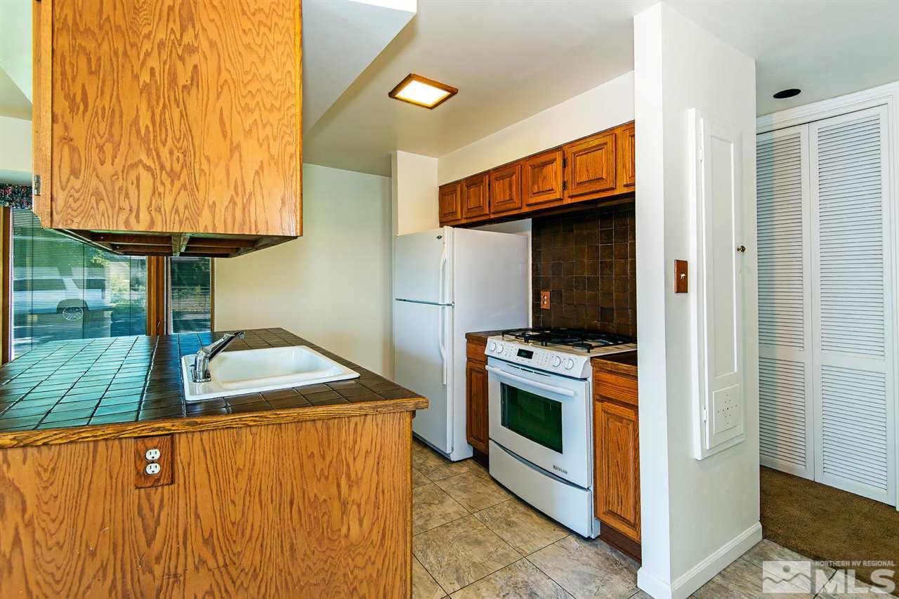 610 Robin Street Reno, NV 89509 - Photo 10 of 23 a kitchen with a stove and a microwave