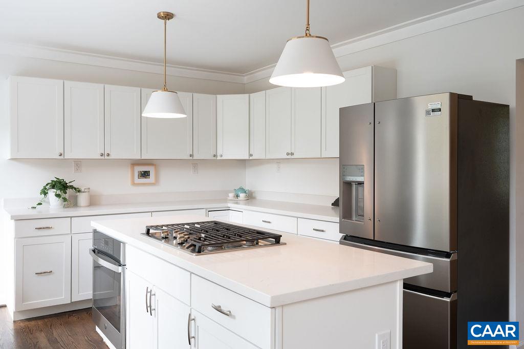 1916 Thomson Road Charlottesville, VA 22903 - Photo 12 of 53 a kitchen with a white stove a refrigerator a sink dishwasher and white cabinets with wooden floor