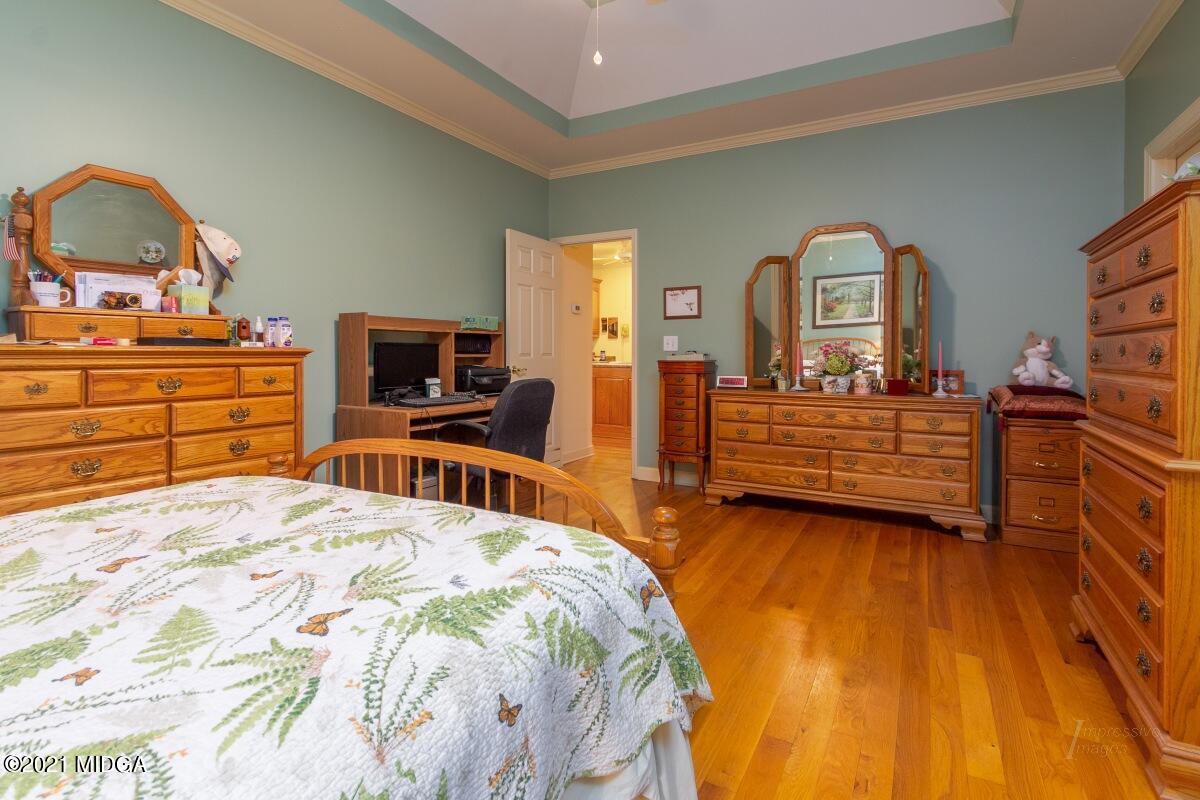 7471 Rivoli Road Macon, GA 31210 - Photo 13 of 26 a bedroom with a bed and wooden floor