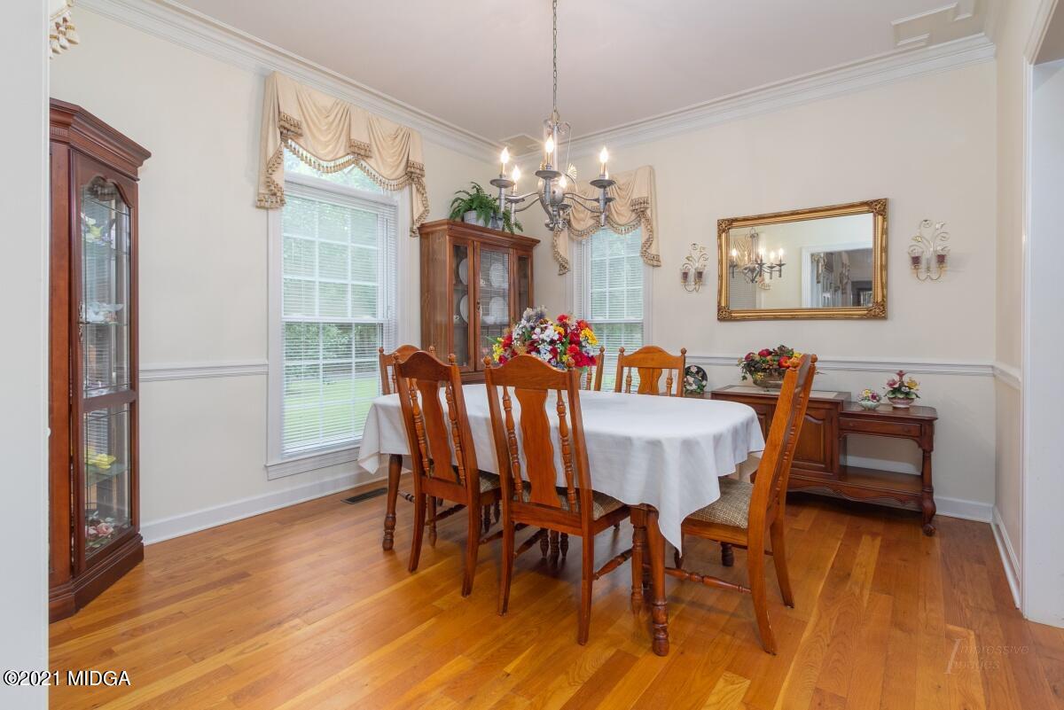 7471 Rivoli Road Macon, GA 31210 - Photo 4 of 26 a view of a dining room with furniture a chandelier and wooden floor