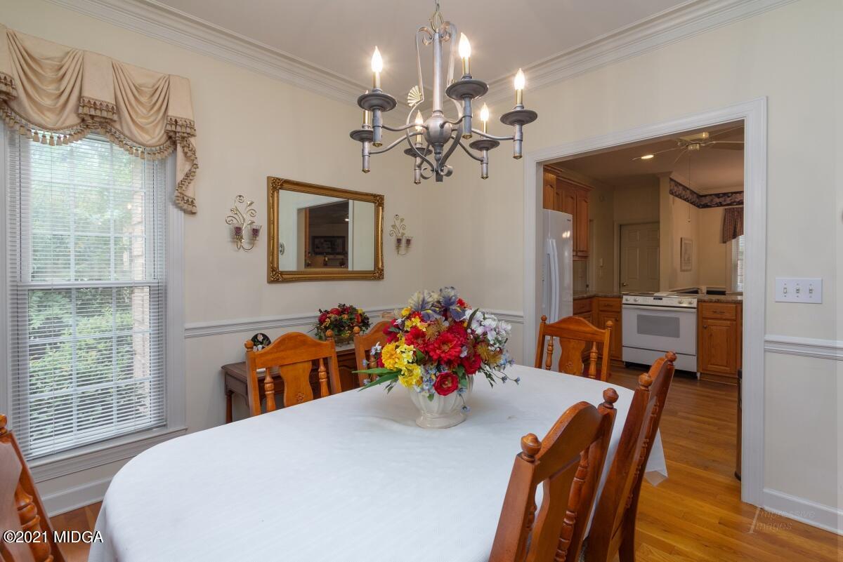7471 Rivoli Road Macon, GA 31210 - Photo 5 of 26 a view of a dining room with furniture a chandelier and wooden floor