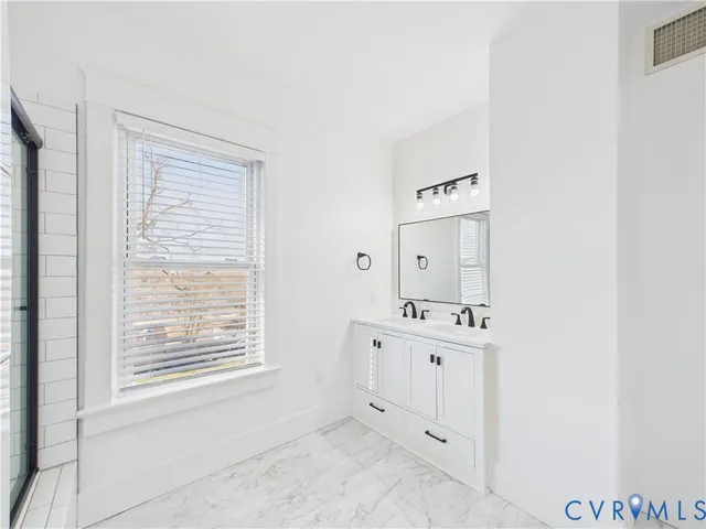 a bathroom with a sink a toilet and mirror