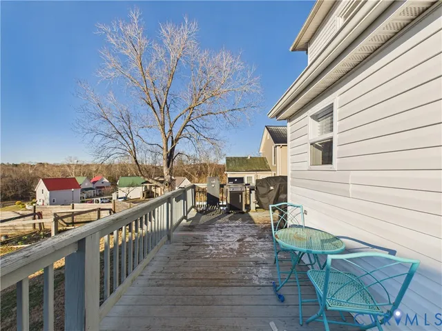 a view of a patio with wooden chairs