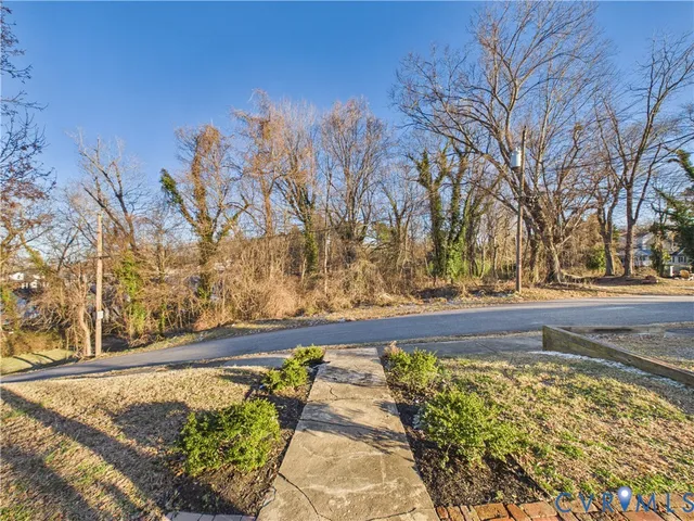 a view of yard with large trees