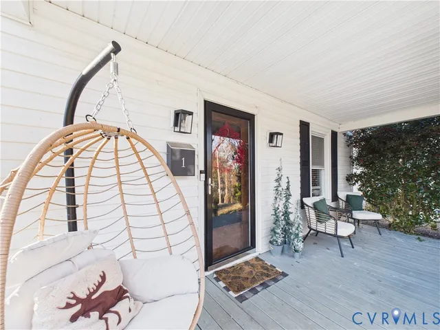 a view of livingroom with furniture wooden floor and front door