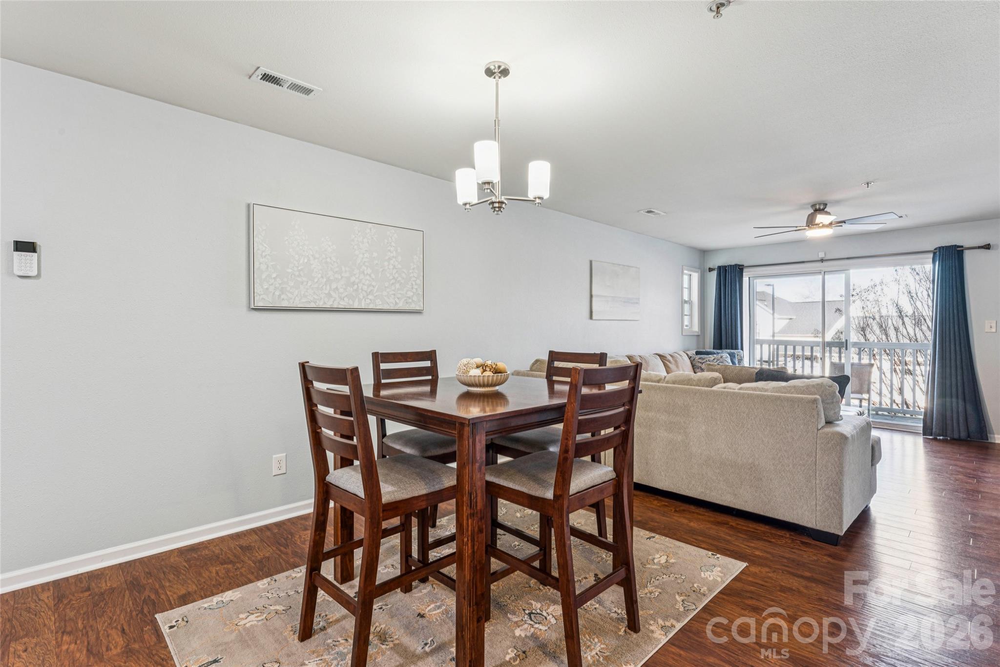 3956 Town Center Road Harrisburg, NC 28075 - Photo 11 of 47 a view of a dining room with furniture wooden floor and chandelier