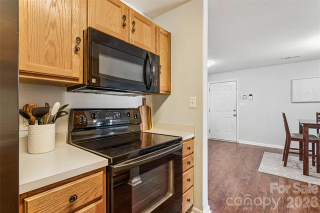 a bedroom with a bed and a lamp on dresser