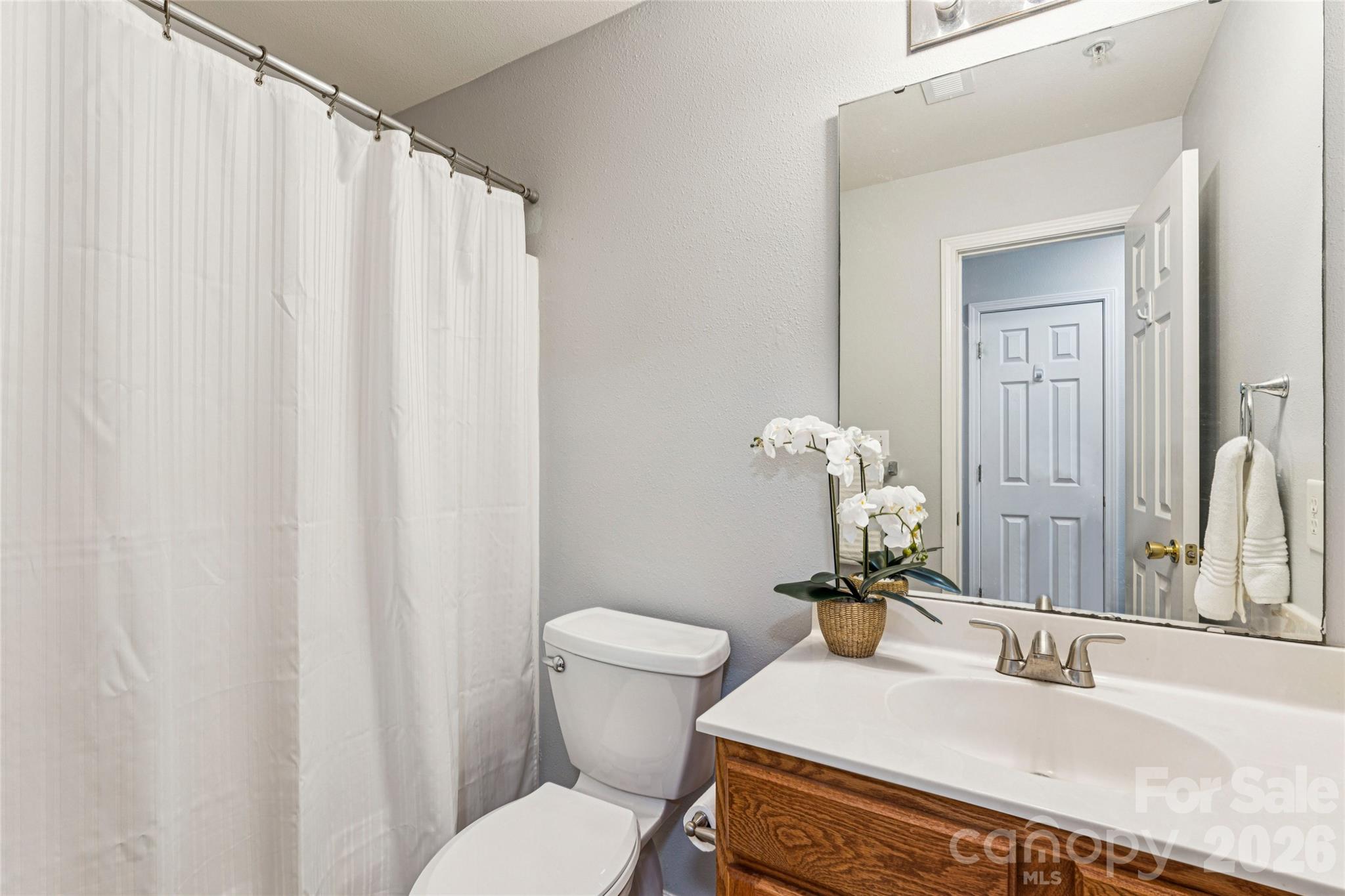 3956 Town Center Road Harrisburg, NC 28075 - Photo 27 of 47 a bathroom with a sink a toilet and mirror