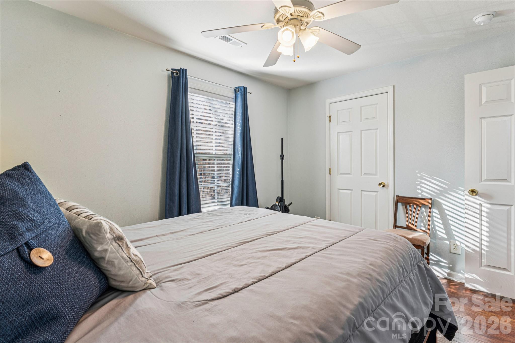 3956 Town Center Road Harrisburg, NC 28075 - Photo 30 of 47 a bedroom with a bed and a chandelier