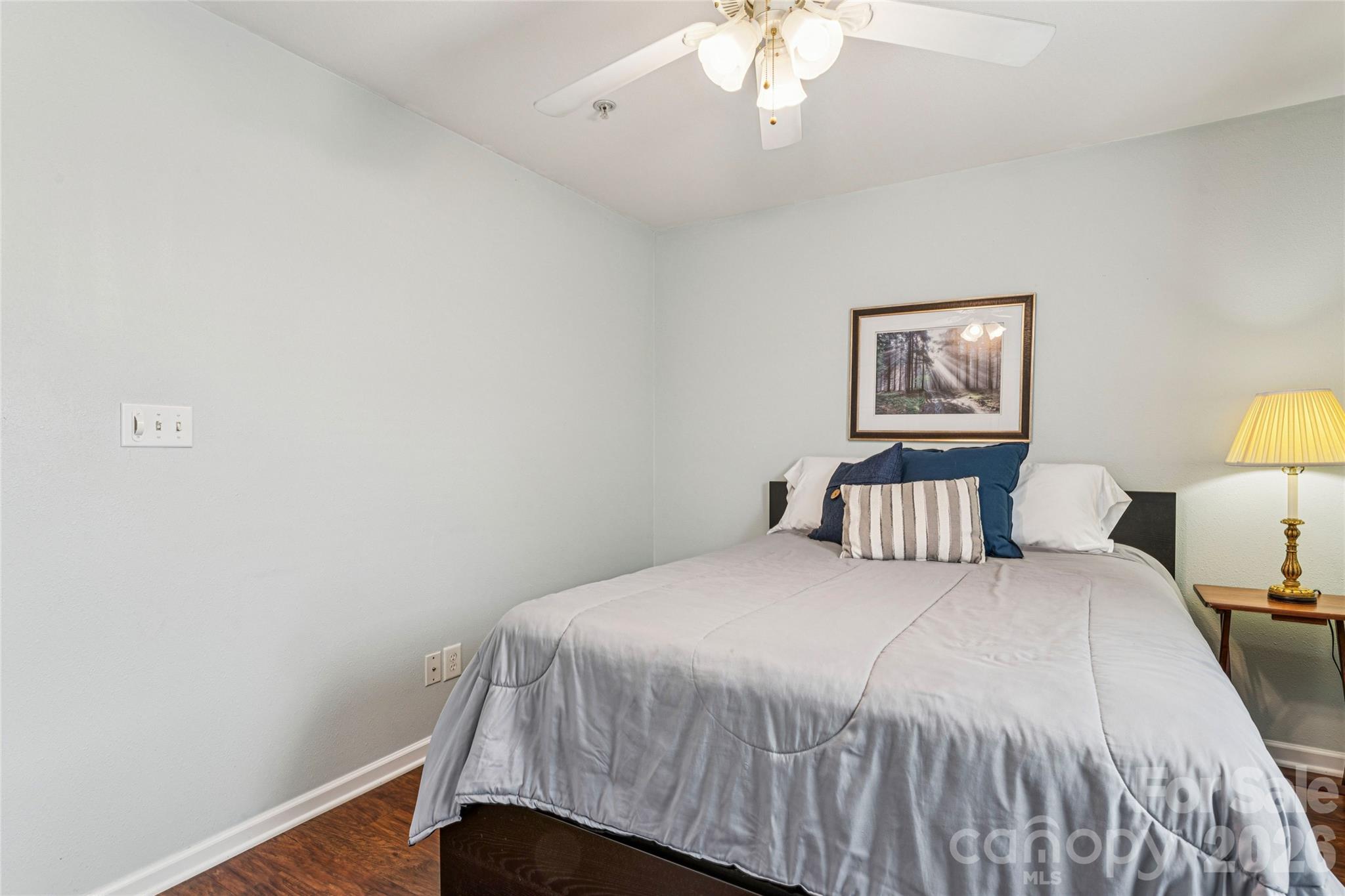 3956 Town Center Road Harrisburg, NC 28075 - Photo 31 of 47 a bedroom with a bed and a lamp on dresser