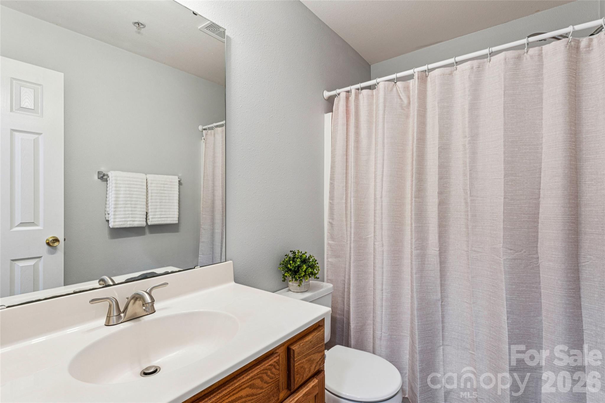3956 Town Center Road Harrisburg, NC 28075 - Photo 33 of 47 a bathroom with a sink and a mirror