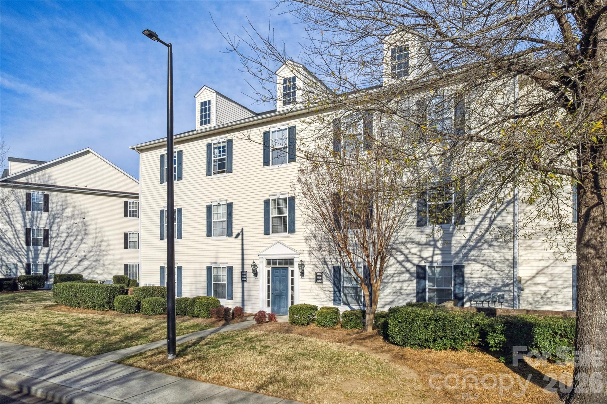 3956 Town Center Road Harrisburg, NC 28075 - Photo 41 of 47 a view of a white house next to a road with big trees