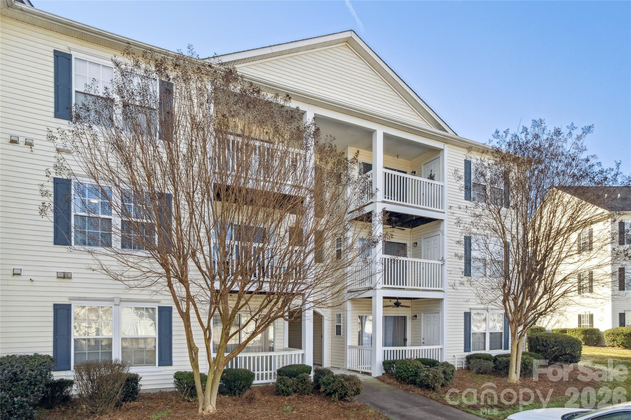 3956 Town Center Road Harrisburg, NC 28075 - Photo 6 of 47 a front view of a building with lot of trees
