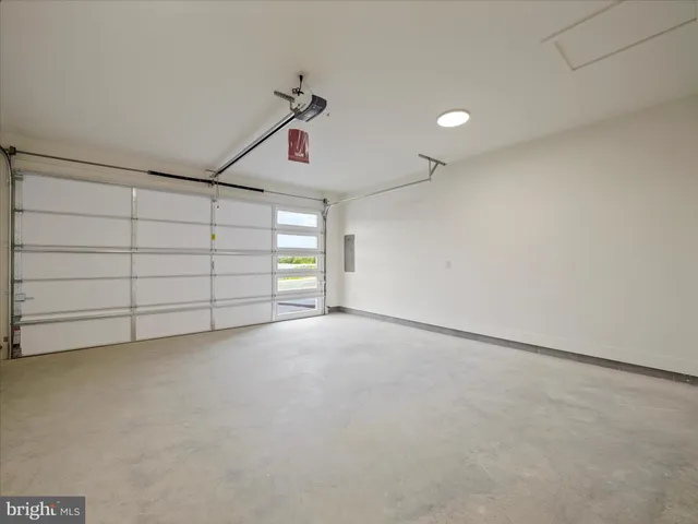 an empty room with windows and ceiling fan