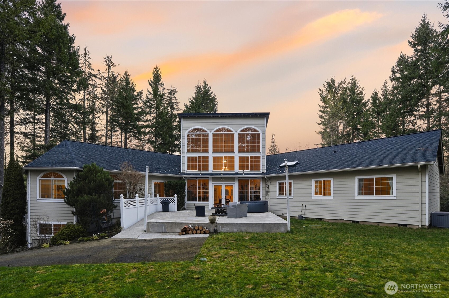 18680 Northwest Hintzville Road Seabeck, WA 98380 - Photo 1 of 40 a front view of a house with a yard table and chairs