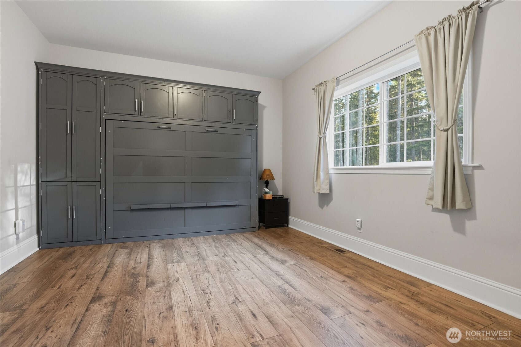 18680 Northwest Hintzville Road Seabeck, WA 98380 - Photo 14 of 40 an empty room with wooden floor and windows