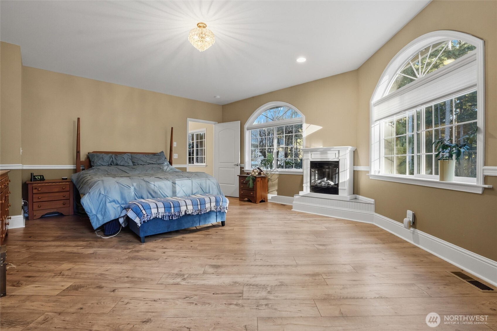 18680 Northwest Hintzville Road Seabeck, WA 98380 - Photo 18 of 40 a bedroom with a large bed and a large window