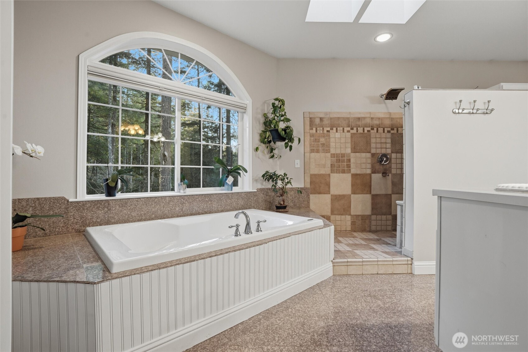 18680 Northwest Hintzville Road Seabeck, WA 98380 - Photo 20 of 40 a bath tub sitting next to a bathroom sink