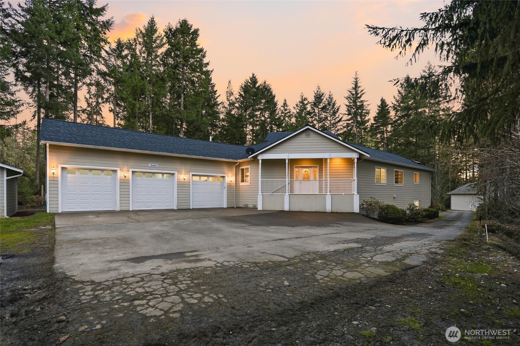 18680 Northwest Hintzville Road Seabeck, WA 98380 - Photo 2 of 40 a front view of a house with a yard and garage