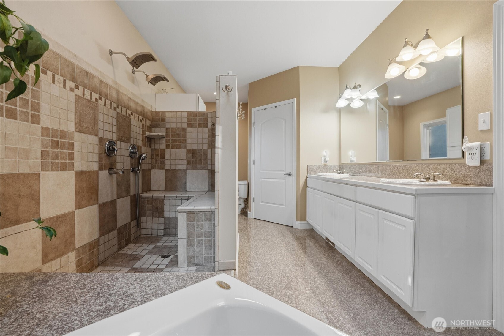 18680 Northwest Hintzville Road Seabeck, WA 98380 - Photo 21 of 40 a spacious bathroom with a granite countertop sink a mirror and shower