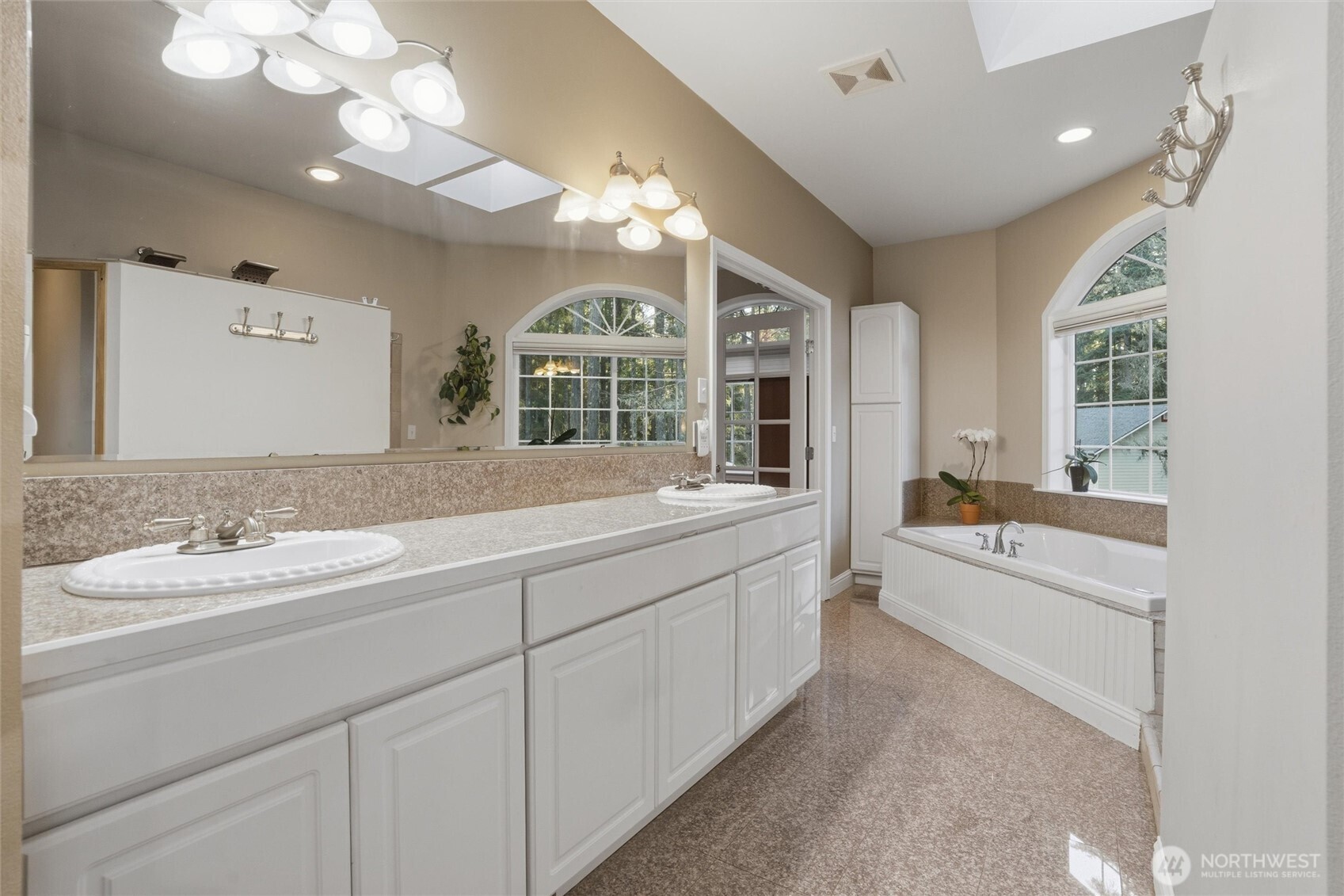 18680 Northwest Hintzville Road Seabeck, WA 98380 - Photo 22 of 40 a bathroom with a granite countertop sink mirror and bathtub