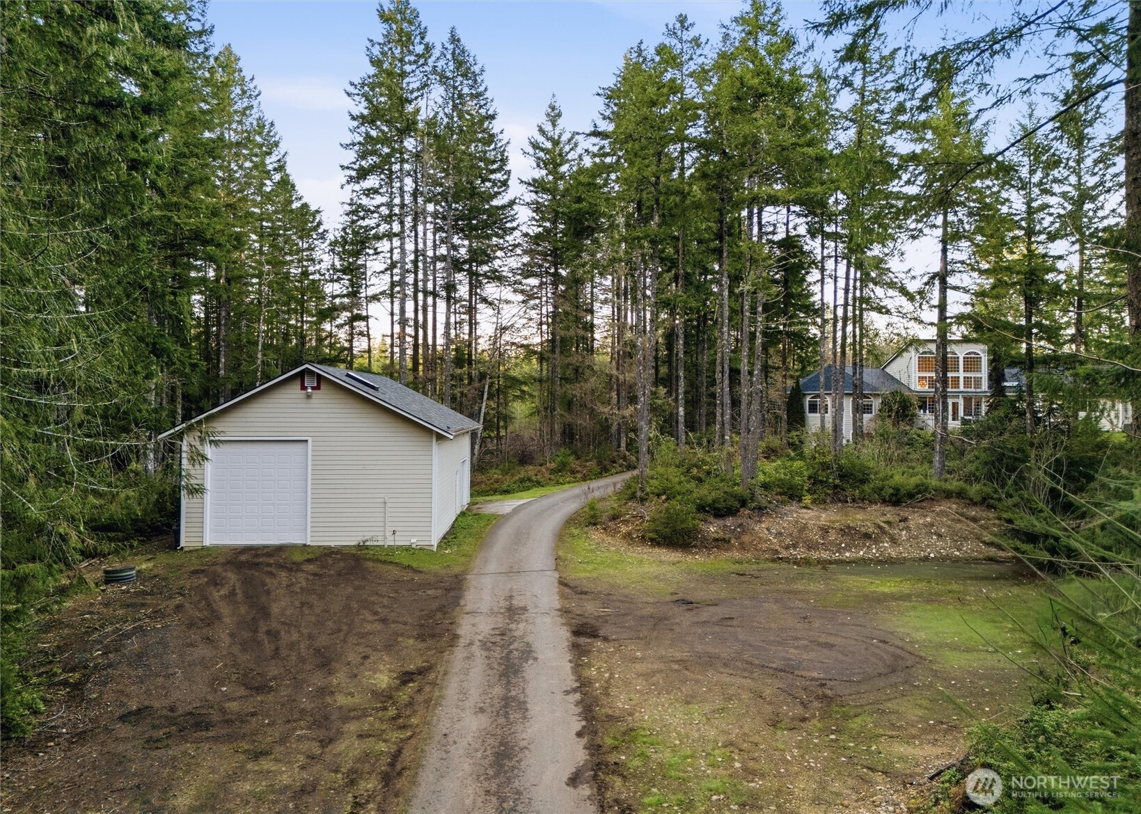18680 Northwest Hintzville Road Seabeck, WA 98380 - Photo 26 of 40 a view of a house with a yard and large tree