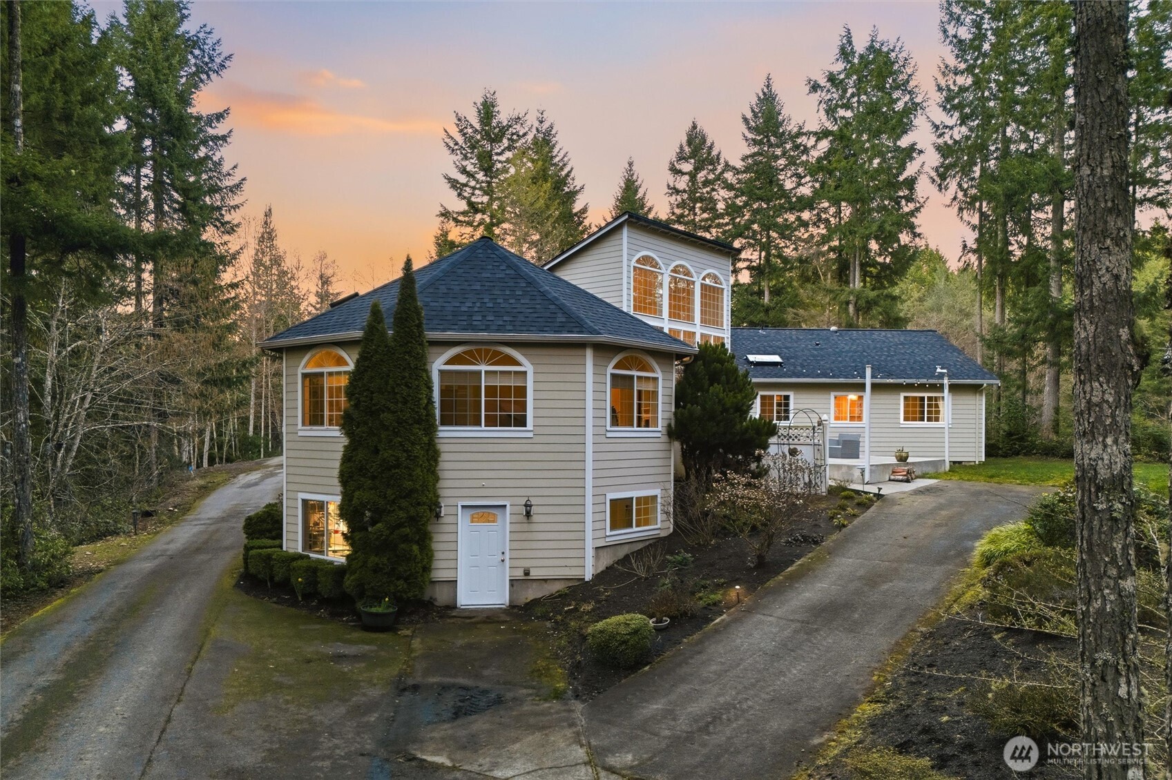 18680 Northwest Hintzville Road Seabeck, WA 98380 - Photo 3 of 40 a front view of a house with a garden