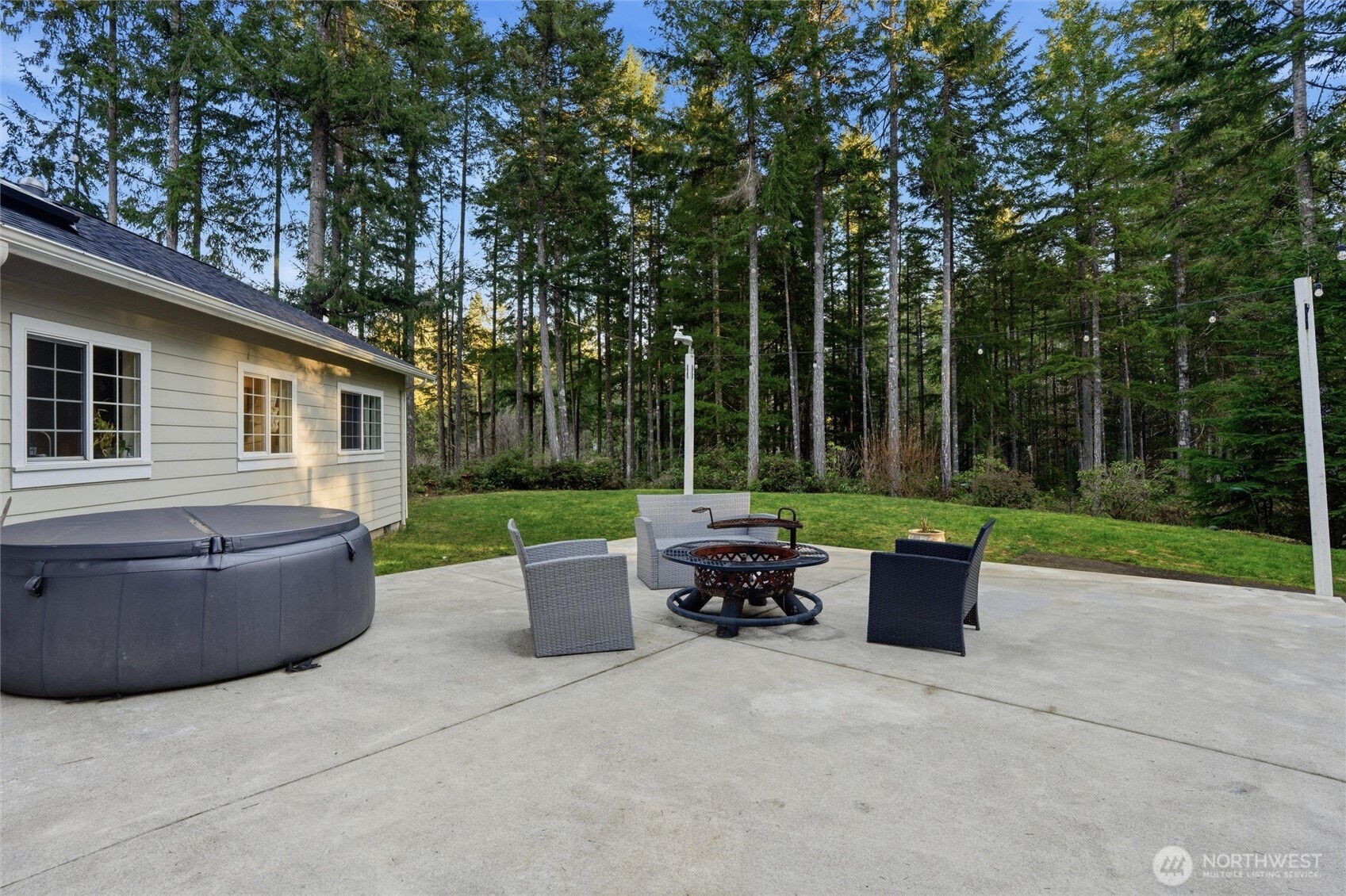 18680 Northwest Hintzville Road Seabeck, WA 98380 - Photo 32 of 40 a view of outdoor sitting area with couch and wooden fence